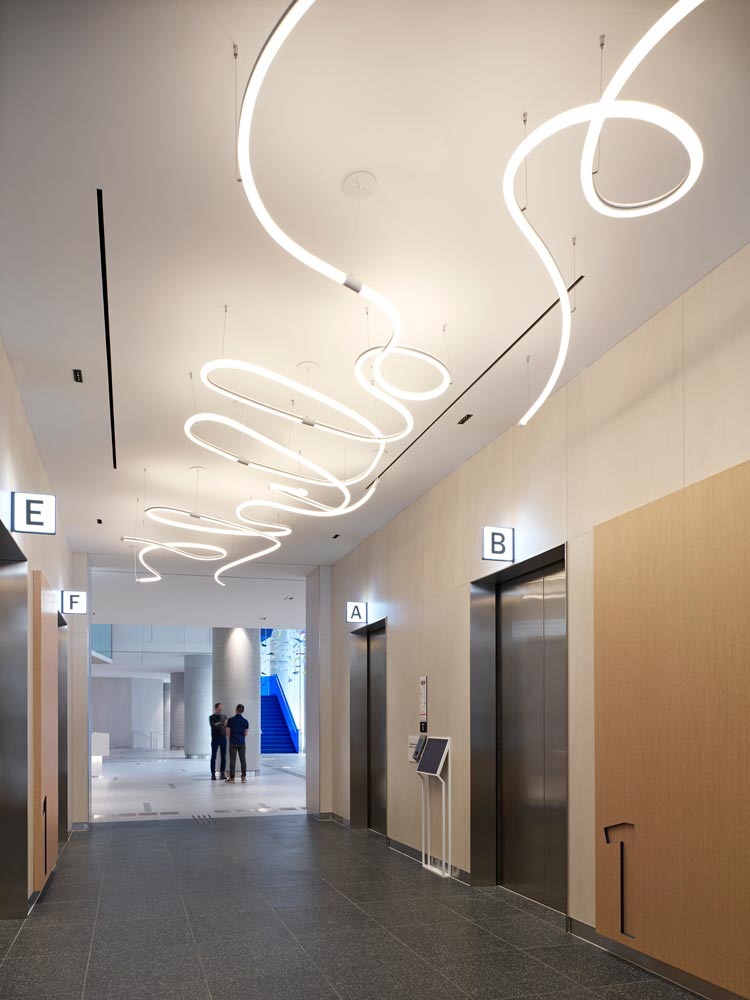 Elevator lobby with whimsical and fun curved light fixtures