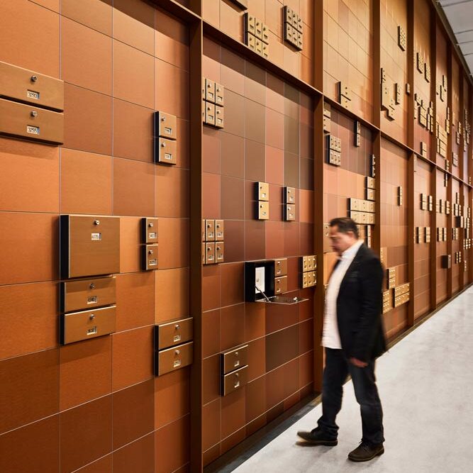Atrium mailbox feature wall with a man standing and opening one of them