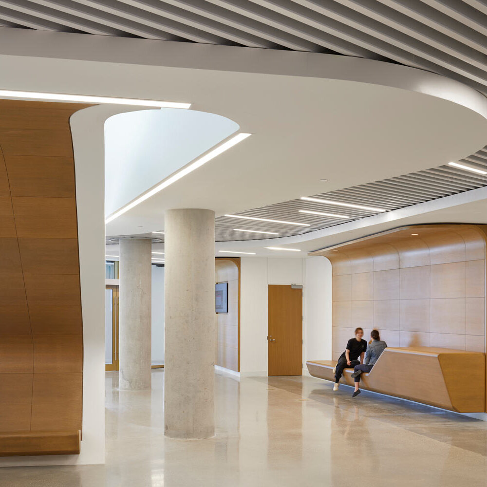 A quiet area of the atrium space featuring a practical millwork seating element