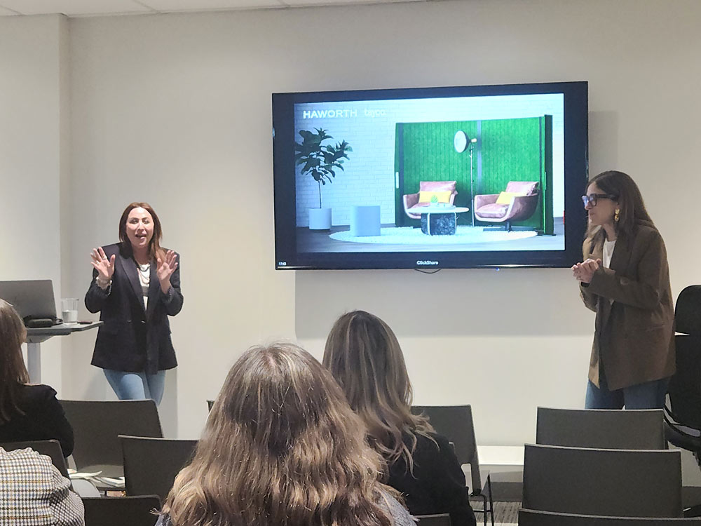 A sponsor discussing their products and services in front of an audience.