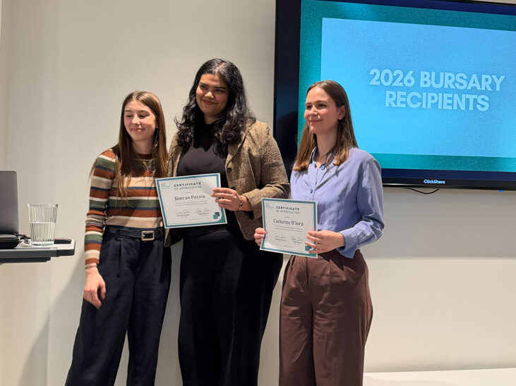Catherine D’iorio and Simran Potnis posing on camera while standing, with their certifications